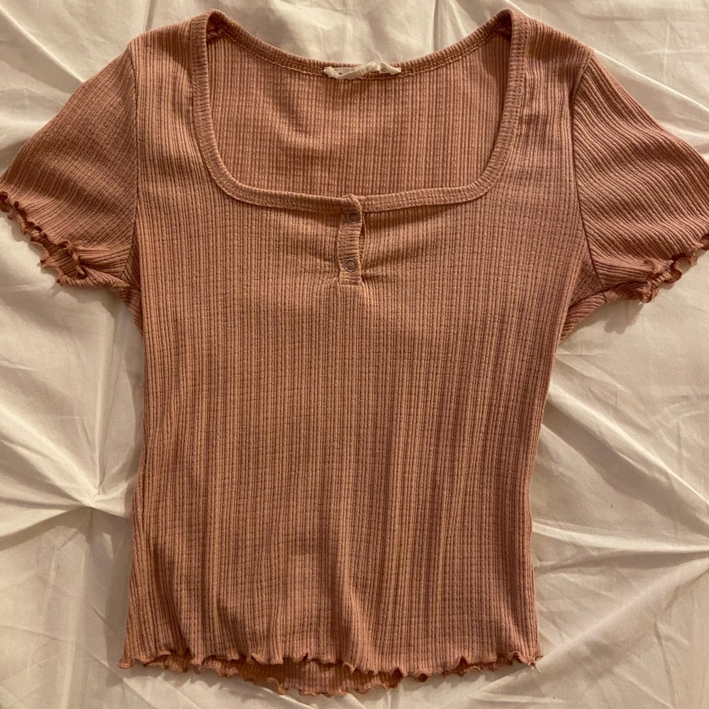 Pink crop top with buttons.